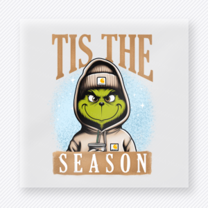Tis the Season Green Hoodie Tan Blue Christmas DTF transfer with Tis the Season lettering with a green character-inspired face in a tan hoodie holding an iced drink on a soft blue background
