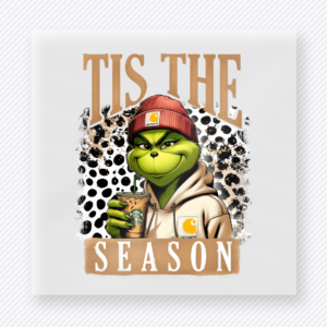 Tis the Season Green Red Beanie Cowhide Christmas DTF transfer with Tis the Season lettering with a green character-inspired face in a red beanie and cream hoodie holding an iced drink on a cowhide background