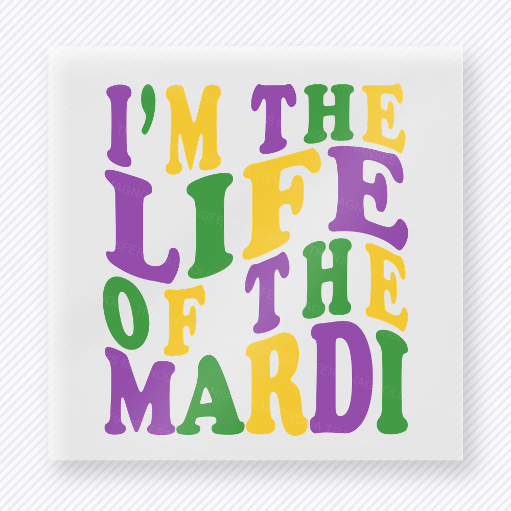 Im The Life Of The Mardi DTF transfer mockup with im The Life Of The Mardi wording uses stacked purple, green, and gold letters for a playful carnival statement.